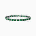 The Brasilica 14K White Gold Emerald Tennis Bracelet features a continuous row of round green gemstones in prong settings, showcased on a white background.