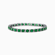 The Brasilica 14K White Gold Emerald Tennis Bracelet features a continuous row of round green gemstones in prong settings, showcased on a white background.
