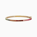 The Watercolors 14K Yellow Gold Multi Sapphire Tennis Bracelet features square-cut sapphires in a rainbow gradient—from green and blue to yellow, orange, red, and pink—set in yellow gold and shown on a white background.