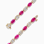 The 14K Yellow Gold Pink Sapphire and Diamond Tennis Bracelet features alternating oval pink sapphires and rectangular white diamonds set in an intricate yellow gold band.