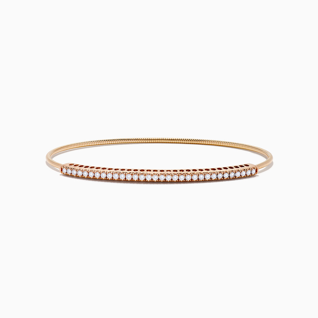 The 14K Rose Gold Flexible Diamond Bangle features a sleek row of sparkling white diamonds along the top, offering a simple, elegant, and symmetrical design with a smooth polished finish.