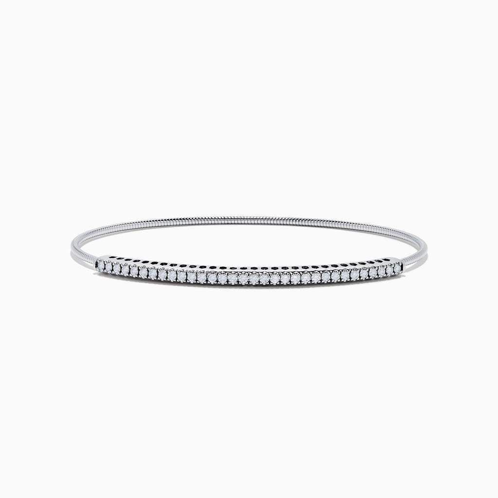The 14K White Gold Flexible Diamond Bangle features a row of sparkling diamonds set along the top in a minimalist, elegant design, displayed on a plain white background.