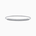 The 14K White Gold Flexible Diamond Bangle features a row of sparkling diamonds set along the top in a minimalist, elegant design, displayed on a plain white background.