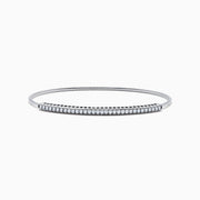 The 14K White Gold Flexible Diamond Bangle features a row of sparkling diamonds set along the top in a minimalist, elegant design, displayed on a plain white background.