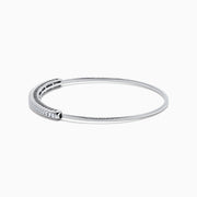 The 14K White Gold Flexible Diamond Bangle features a row of sparkling diamonds set along the top in a minimalist, elegant design, displayed on a plain white background.