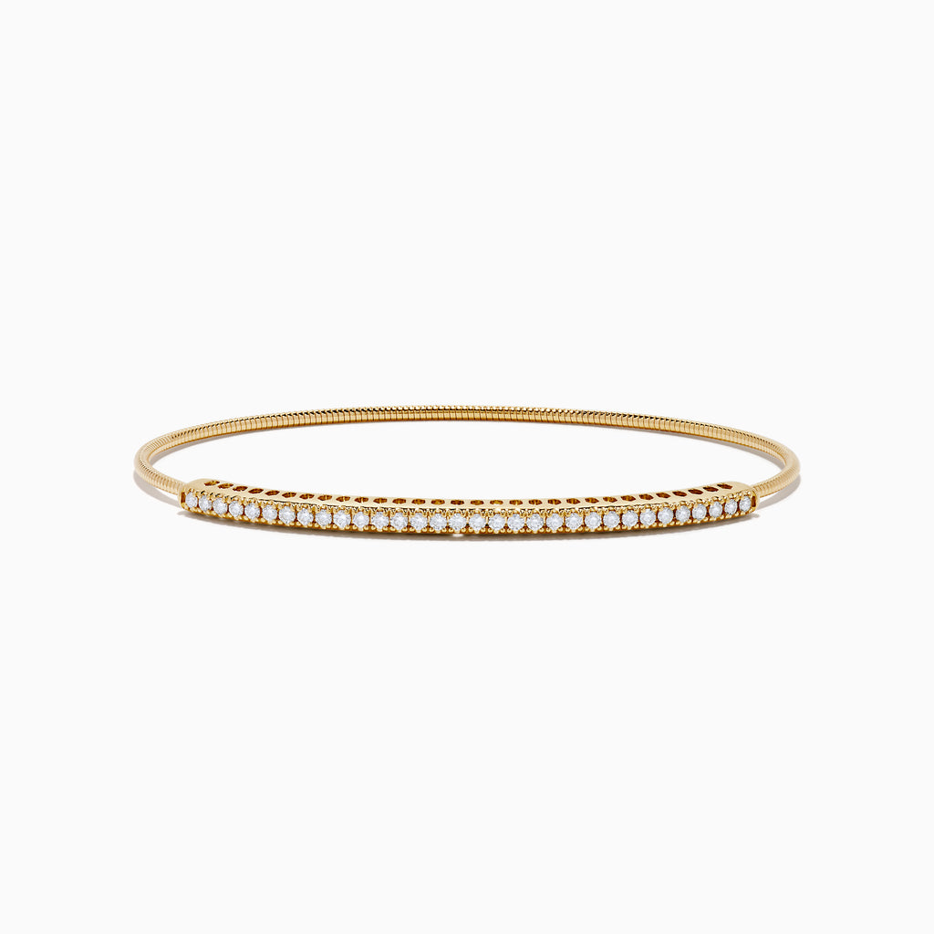 The 14K Yellow Gold Flexible Diamond Bangle features a slender design with sparkling diamonds set along the top half, shown against a white background.