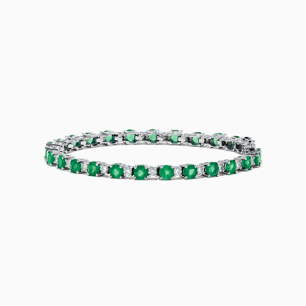 The Brasilica 14K White Gold Emerald and Diamond Tennis Bracelet features alternating round green emeralds and clear diamonds, beautifully displayed on a white background.