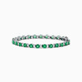 The Brasilica 14K White Gold Emerald and Diamond Tennis Bracelet features alternating round green emeralds and clear diamonds, beautifully displayed on a white background.