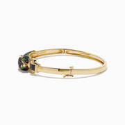 The Signature 14K Yellow Gold Black Diamond Panther Bangle showcases a black panther head with green eyes and a sparkling loop clasp set with small clear stones.