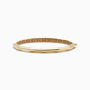 The 14K Yellow Gold Geometric Bamboo Bangle features an octagonal shape, a reflective surface, patterned textured sides in brown and gold hues, and slender raised edges inspired by geometric bamboo design.