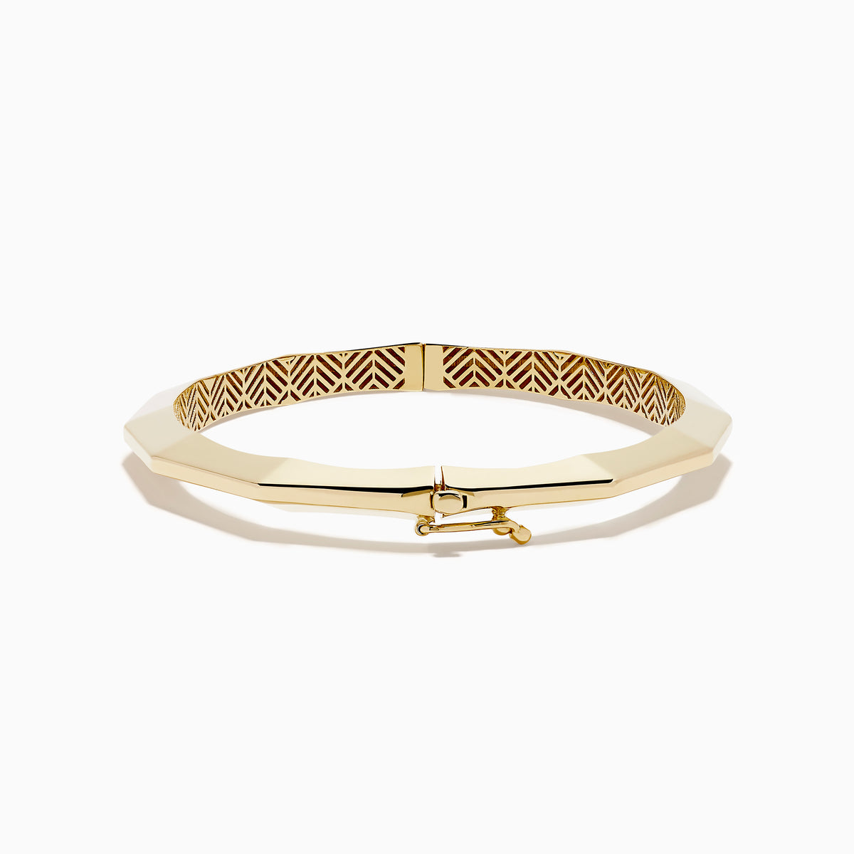 The 14K Yellow Gold Geometric Bamboo Bangle features an octagonal shape, a reflective surface, patterned textured sides in brown and gold hues, and slender raised edges inspired by geometric bamboo design.