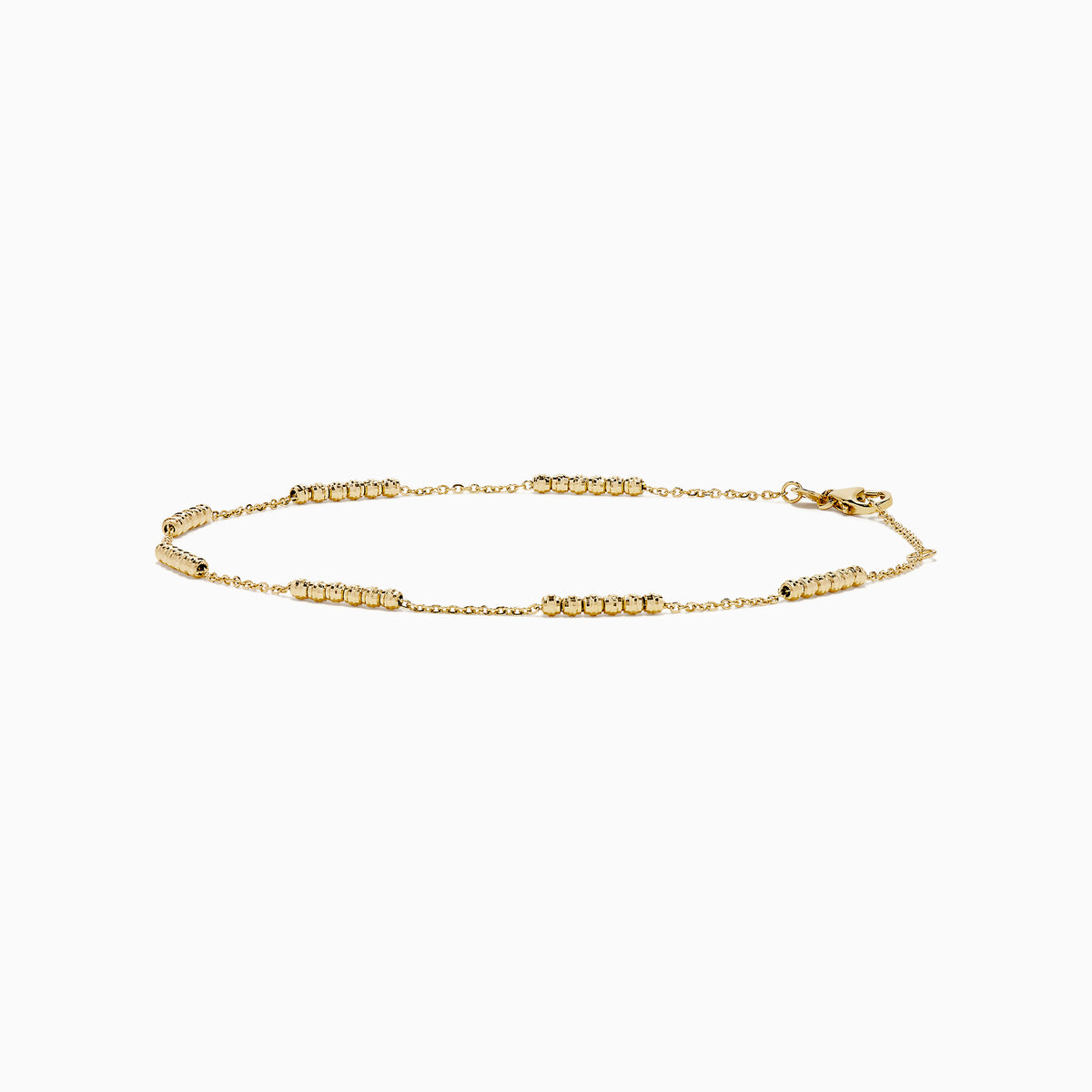 The 14K Yellow Gold Beaded Station Anklet features a delicate fine chain with evenly spaced bead clusters and a secure lobster clasp.
