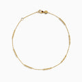 The 14K Yellow Gold Beaded Station Anklet features a delicate fine chain with evenly spaced bead clusters and a secure lobster clasp.