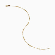 The 14K Yellow Gold Beaded Station Anklet features a delicate fine chain with evenly spaced bead clusters and a secure lobster clasp.