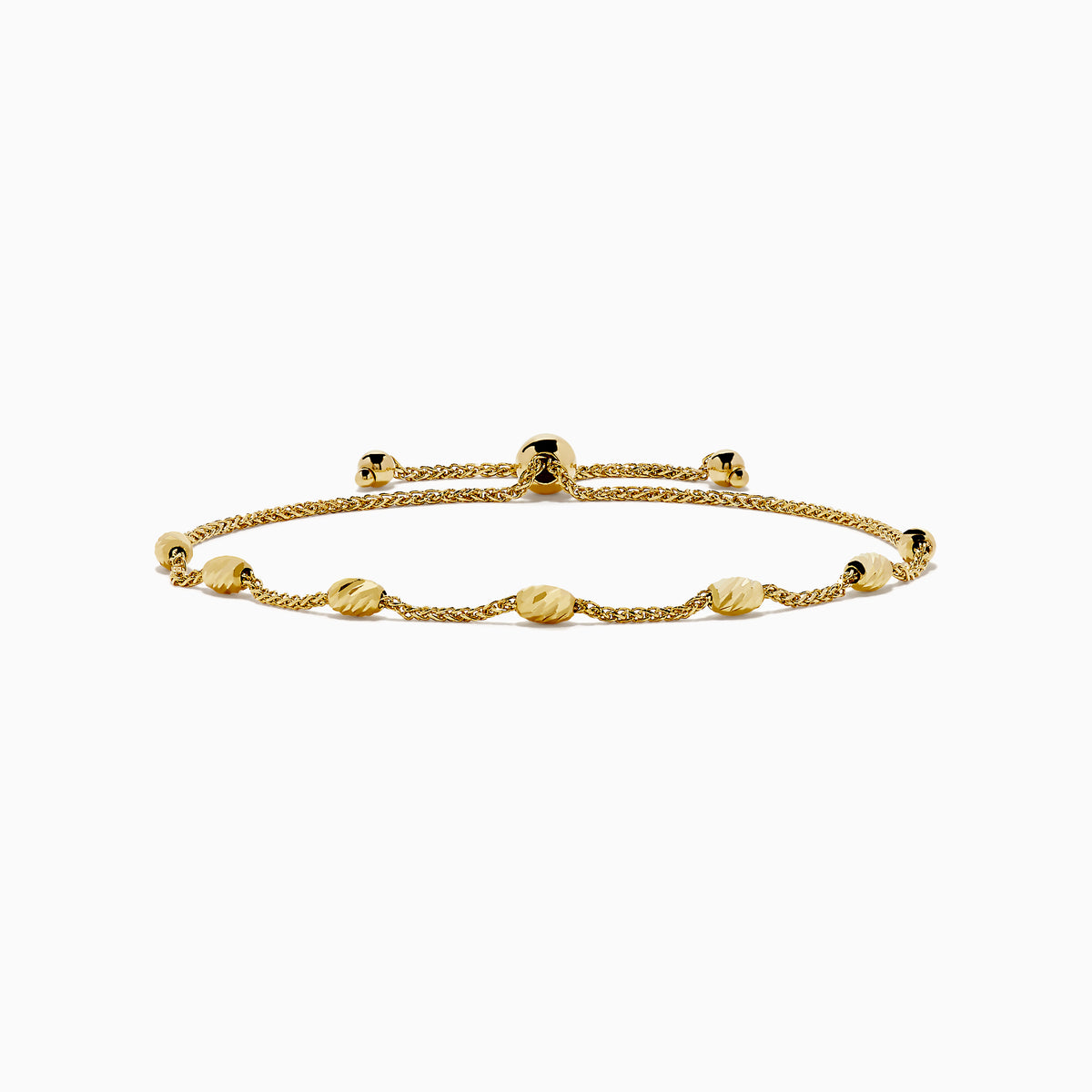 The 14K Yellow Gold Wheat Bolo Chain Bracelet features a twisted rope design with evenly spaced textured gold beads and an adjustable sliding clasp with decorative end pieces.
