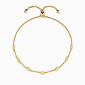 The 14K Yellow Gold Wheat Bolo Chain Bracelet features a twisted rope design with evenly spaced textured gold beads and an adjustable sliding clasp with decorative end pieces.