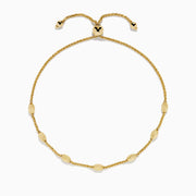 The 14K Yellow Gold Wheat Bolo Chain Bracelet features a twisted rope design with evenly spaced textured gold beads and an adjustable sliding clasp with decorative end pieces.