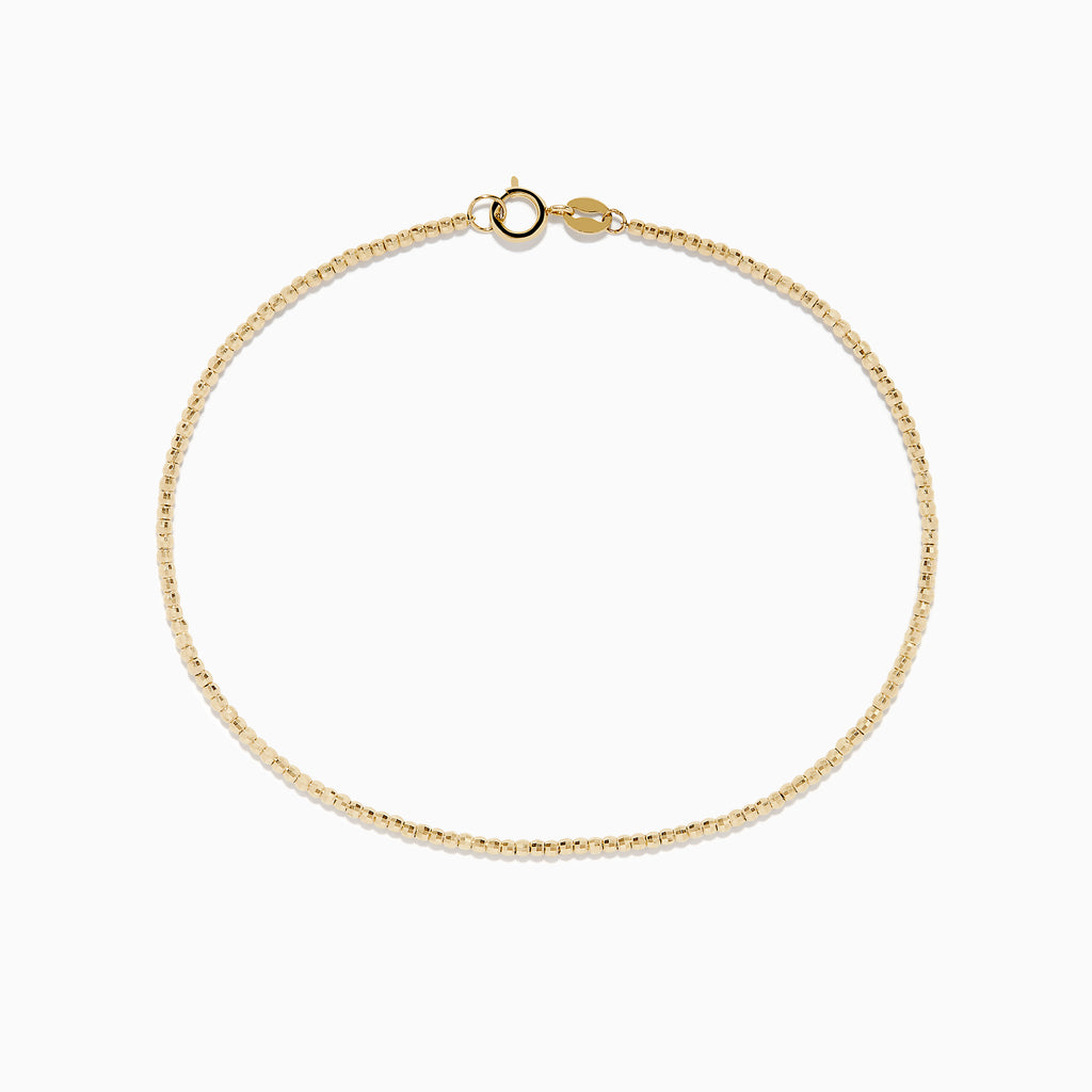 The 14K Yellow Gold Bead Bracelet features a delicate gold chain and small round clasp, shown on a plain white background.