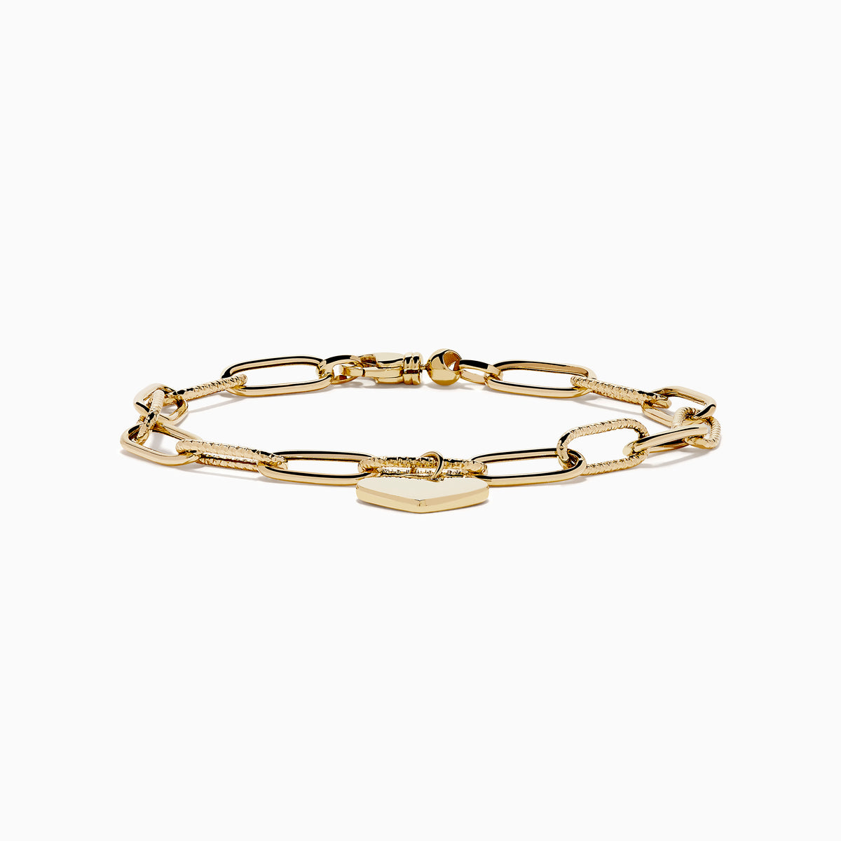 A 14K yellow gold paperclip chain bracelet featuring elongated textured links and a heart charm at the center, displayed on a white background.