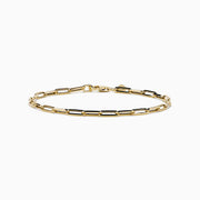 The 14K Yellow Gold Hollow Paperclip Chain Bracelet features elongated chain links and a small round charm near the clasp, shown on a white background.