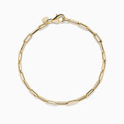 The 14K Yellow Gold Hollow Paperclip Chain Bracelet features elongated chain links and a small round charm near the clasp, shown on a white background.