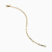 The 14K Yellow Gold Hollow Paperclip Chain Bracelet features elongated chain links and a small round charm near the clasp, shown on a white background.