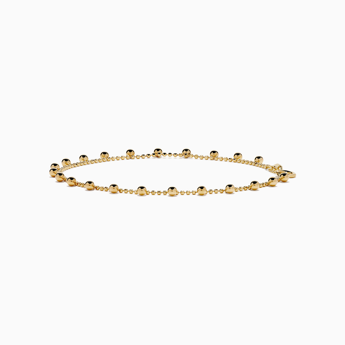 The 14K Yellow Gold Tassel Bead Chain Bracelet features small, evenly spaced round charms on a delicate chain, finished with a secure lobster clasp closure.