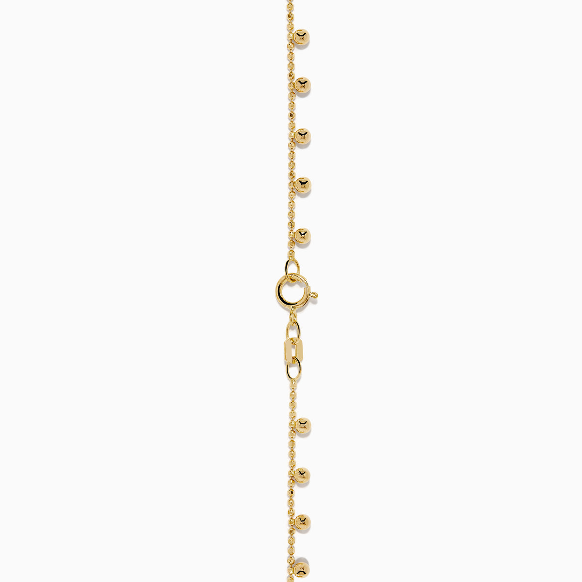 The 14K Yellow Gold Tassel Bead Chain Bracelet features small, evenly spaced round charms on a delicate chain, finished with a secure lobster clasp closure.
