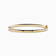 The 14K Yellow Gold Hollow Bangle features a smooth, round design with a small clasp, crafted in polished yellow gold and displayed on a white background.