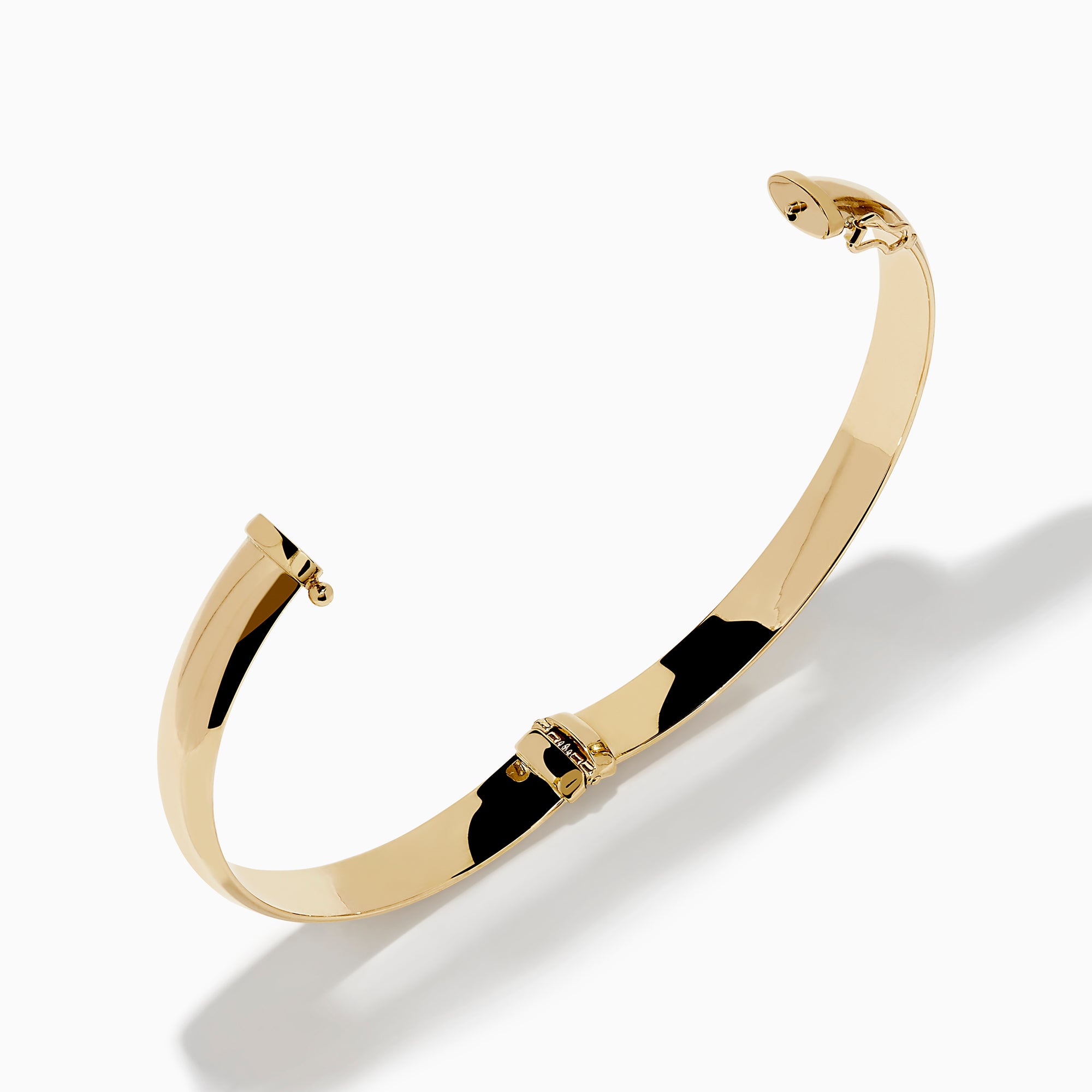 The 14K Yellow Gold Oval with Hinge Bracelet features a polished, smooth surface and classic oval hinge design, displayed against a plain white background.