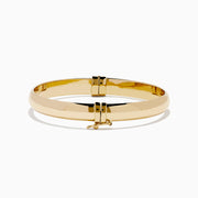 The 14K Yellow Gold Oval with Hinge Bracelet features a polished, smooth surface and classic oval hinge design, displayed against a plain white background.
