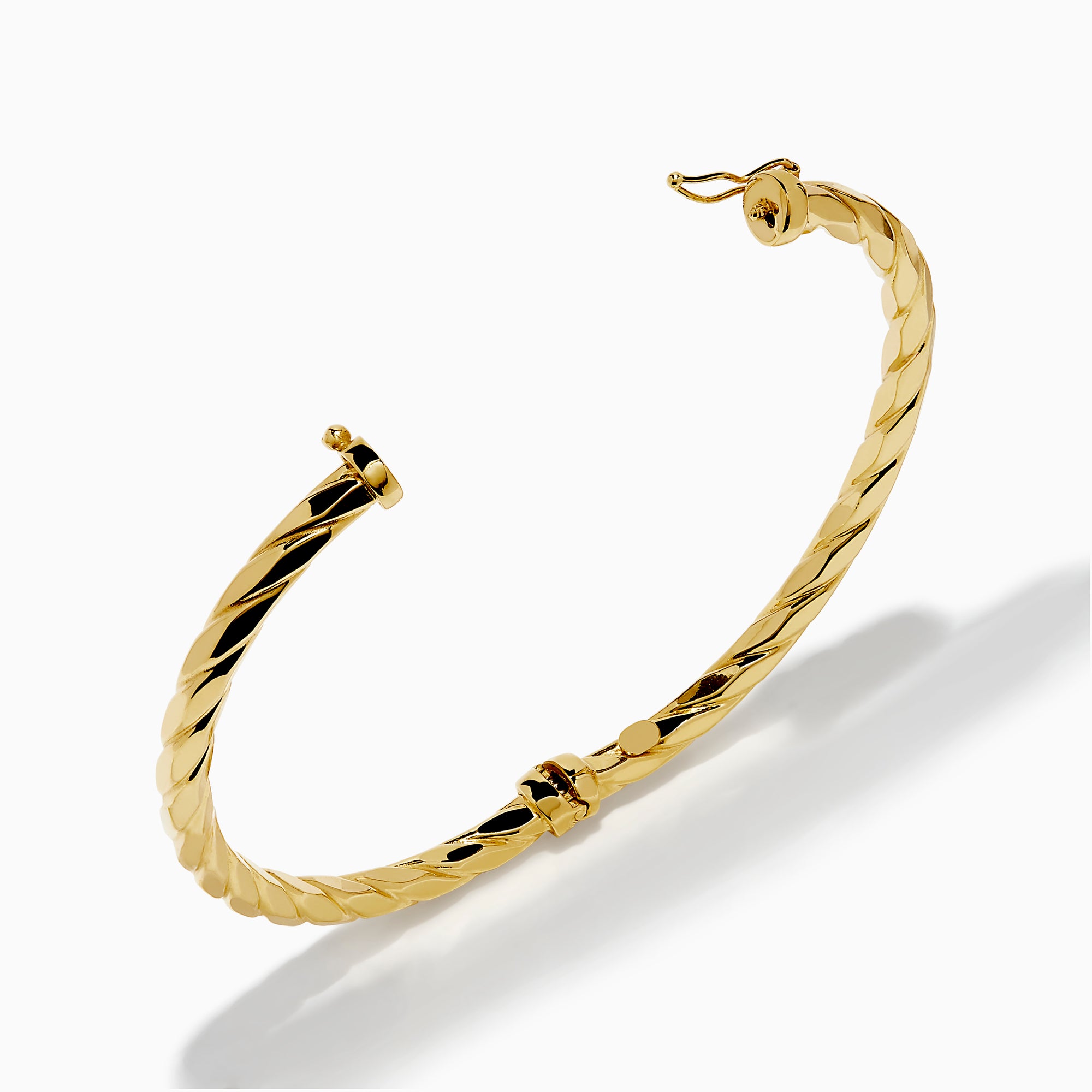 A 14K Yellow Gold Hammered Hinge Bangle featuring a textured finish, showcased on a white background.