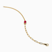 The Ruby Royale 14K Yellow Gold Ruby and Diamond Bracelet showcases a central square ruby framed by sparkling diamonds and delicate chain links, elegantly displayed on a white background.