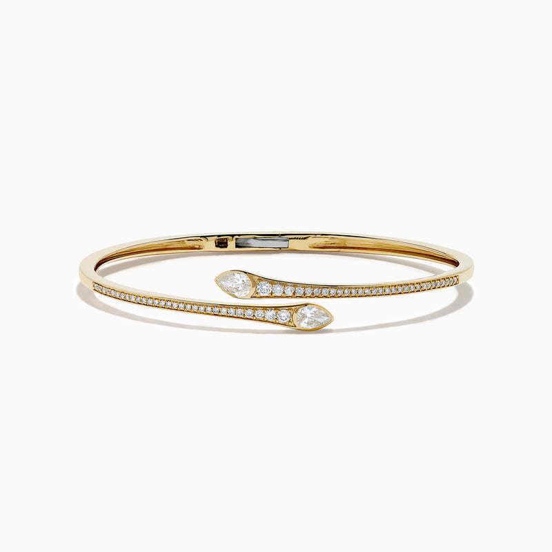 The D'Oro 14k Yellow Gold Diamond Bypass Bangle showcases two overlapping ends tipped with pear-shaped diamonds and a band lined with small round diamonds.