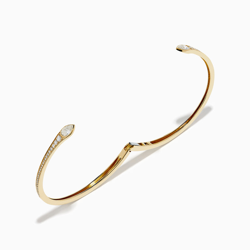 The D'Oro 14k Yellow Gold Diamond Bypass Bangle showcases two overlapping ends tipped with pear-shaped diamonds and a band lined with small round diamonds.