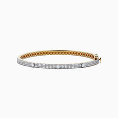 The DOro 14K Yellow Gold Diamond Bangle showcases a honeycomb interior and three large round diamonds set among smaller diamonds on its exterior.