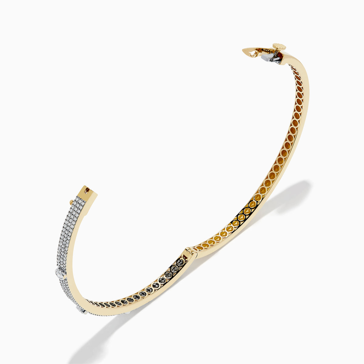 The DOro 14K Yellow Gold Diamond Bangle showcases a honeycomb interior and three large round diamonds set among smaller diamonds on its exterior.