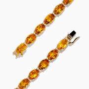 The Sunset 14K Yellow Gold Citrine Tennis Bracelet 19.15 TCW features round, faceted yellow and orange gemstones in an alternating pattern, shown on a white background.