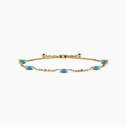 The 14K Yellow Gold Turquoise and Diamond Station Bolo Bracelet features evenly spaced round turquoise stones and sparkling diamonds, finished with an adjustable sliding clasp adorned with small gold beads.