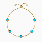 The 14K Yellow Gold Turquoise and Diamond Station Bolo Bracelet features evenly spaced round turquoise stones and sparkling diamonds, finished with an adjustable sliding clasp adorned with small gold beads.