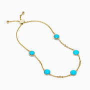 The 14K Yellow Gold Turquoise and Diamond Station Bolo Bracelet features evenly spaced round turquoise stones and sparkling diamonds, finished with an adjustable sliding clasp adorned with small gold beads.