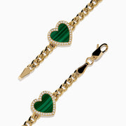The 14K Yellow Gold Malachite and Diamond 5 Motif Heart Bracelet features five green malachite heart charms, each bordered by diamond-accented stones, evenly spaced along a yellow gold chain with a secure clasp.