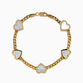 The 14K Yellow Gold Mother of Pearl and Diamond Heart Chain-link Station Bracelet features five white heart-shaped charms bordered with sparkling stones, evenly spaced along a gold chain.