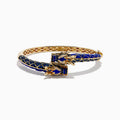 The 14K Yellow Gold Lapis, Blue Sapphire and Diamond Dragon Bangle features two dragon heads facing each other, with a blue enamel scale-inspired band, intricate gold details, and blue sapphire accents.