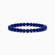 The Men's Lapis Lazuli Beaded Bracelet features polished round blue beads with subtle gold flecks, elegantly displayed on a white background.