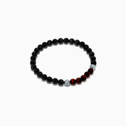 The Men's Meteorite and Tiger's Eye Beaded Bracelet features mainly black beads, five dark red tiger's eye beads at the center, flanked by two silver meteorite beads, strung on elastic and displayed against a white background.