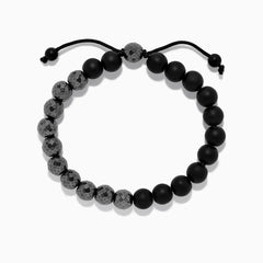 The Mens Beaded Hematite String Bracelet features alternating matte black and faceted dark gray beads on a black adjustable cord with knotted ends—an elegant accessory for any occasion.
