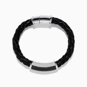 The Mens 925 Sterling Silver Spinel Leather Bracelet features black braided leather, a shiny sterling silver clasp, and a rectangular silver accent with sparkling black spinels, displayed against a white background.