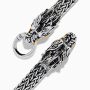 The Mens 925 Silver & 14K Yellow Gold Black Sapphire and Tsavorite Dragon Bracelet features two detailed dragon heads with black sapphire eyes, facing each other and joined by a round clasp.