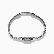 The Mens 925 Sterling Silver Onyx and Black Diamond Bracelet features a woven chain design, a rectangular onyx center stone in a decorative frame, black diamond accents, and a secure lobster clasp closure.